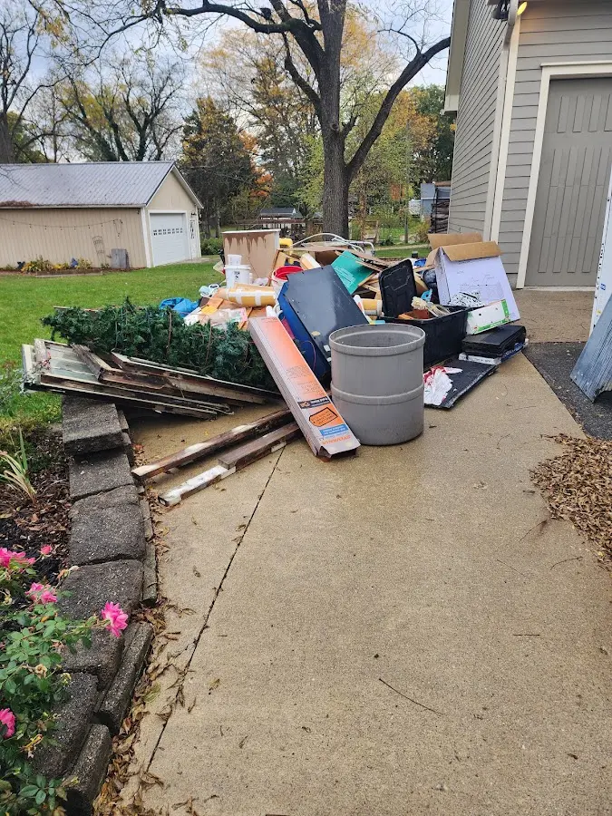 Dumpster being loaded with debris for 12 Yard Dumpster Rental in King George
